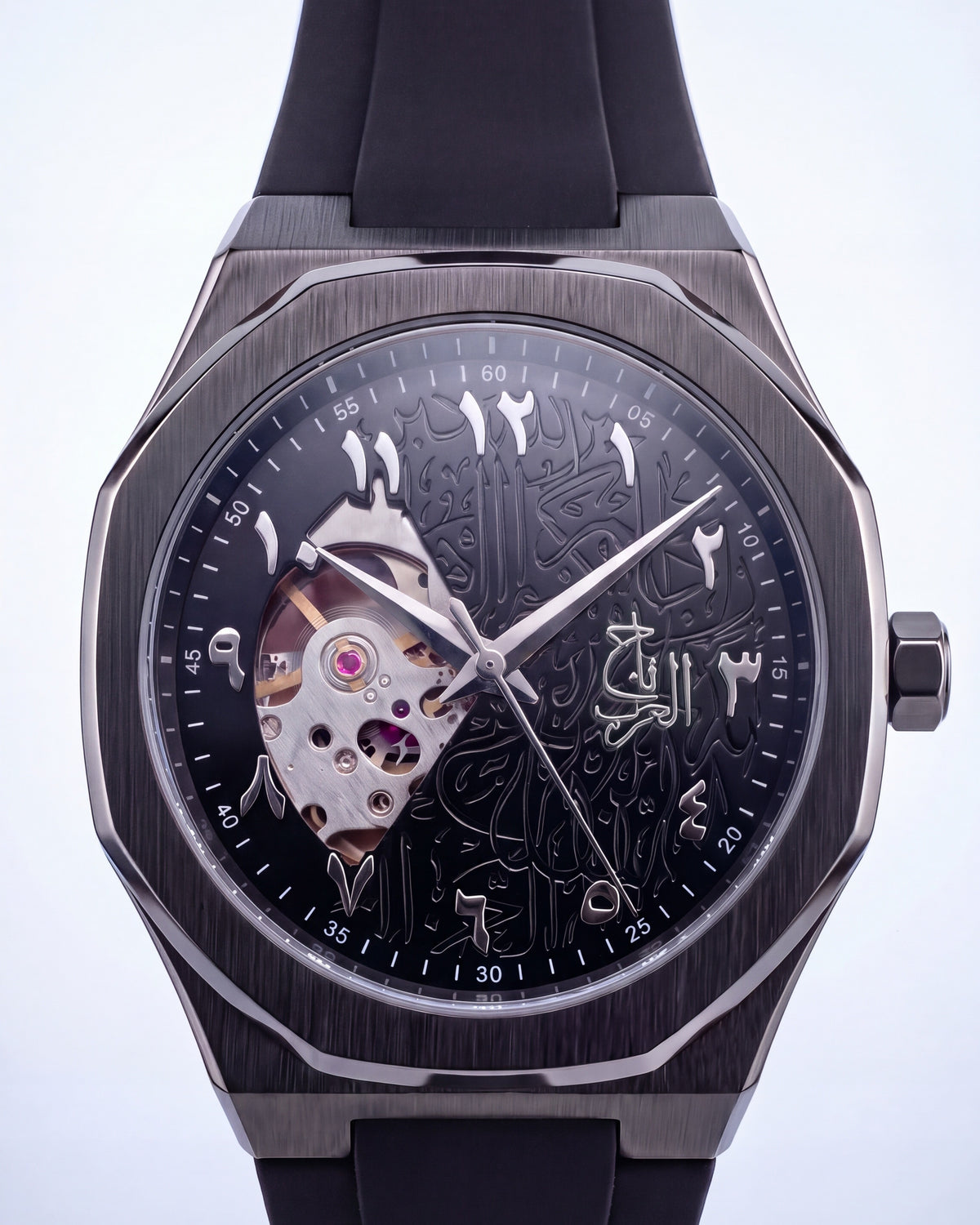 Auto Taj from the front: octagonal gunmetal case, black dial engraved with Arabic calligraphy, open heart at nine