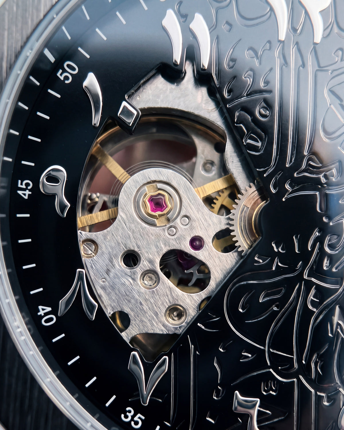 The open heart: silver plate, gold wheels and the ruby, beside the engraved calligraphy